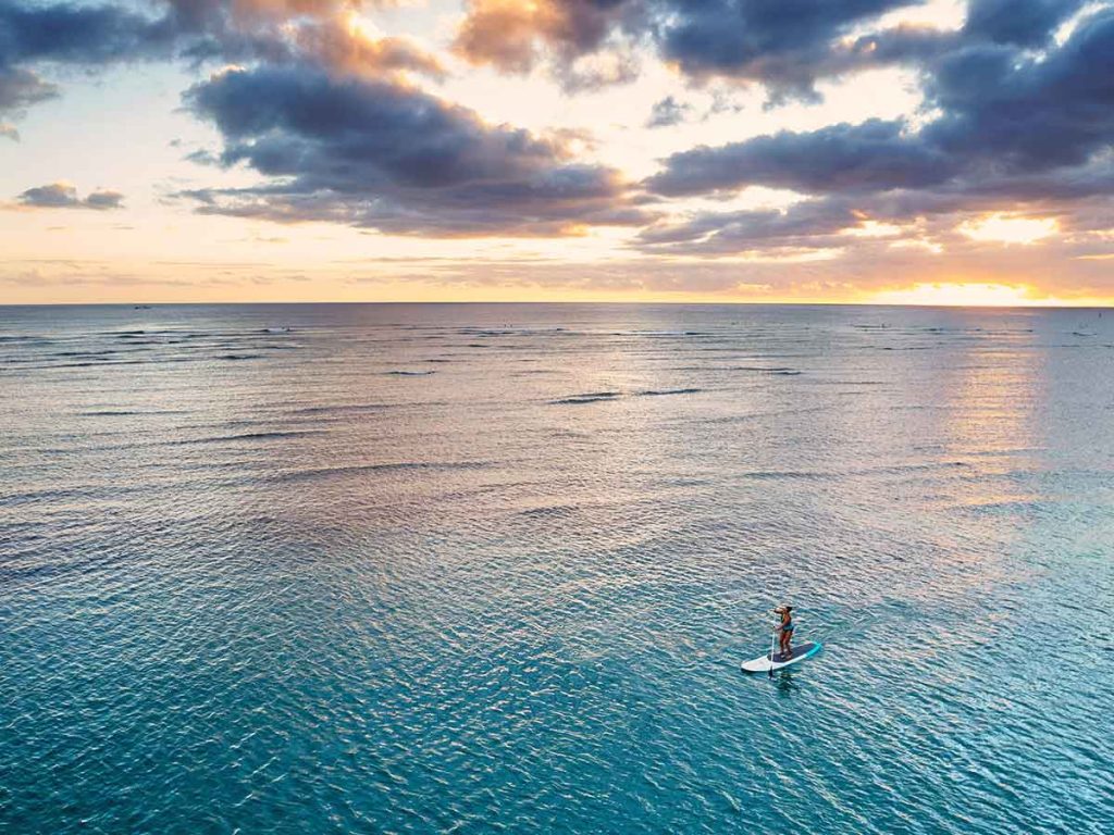 Person paddle boarding in the ocean